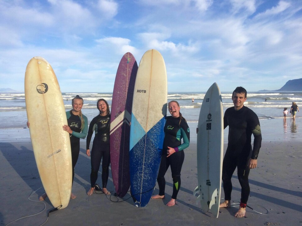 RIDING THE WAVES: Surfing in Muizenberg, South Africa.