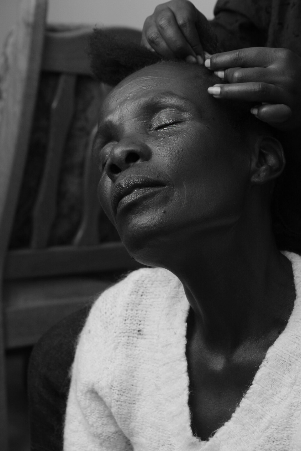 DOWNTIME: Hawa is patiently sitting down while getting her hair done.