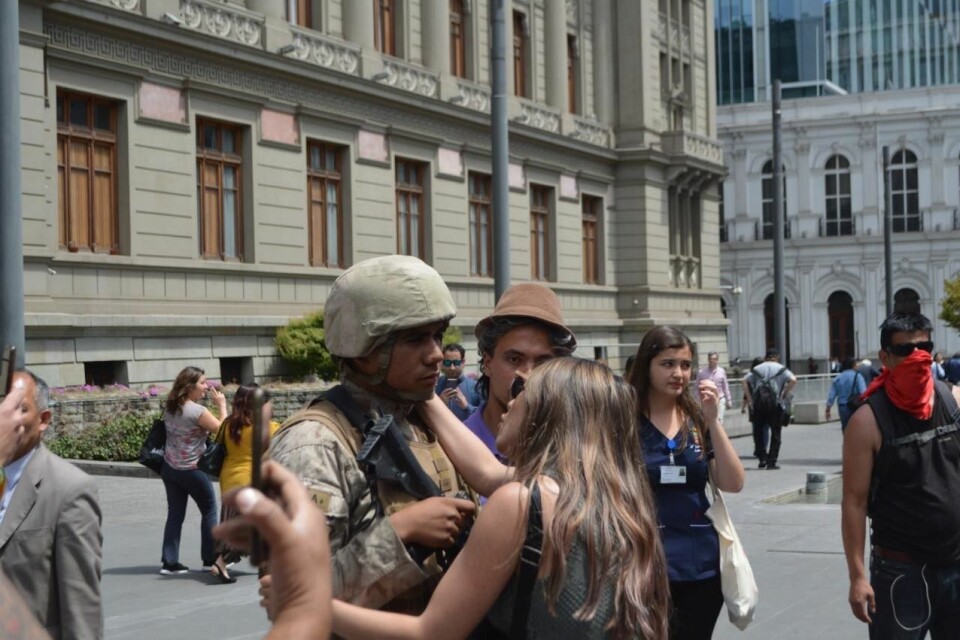 FACE OFF: Protesters confronting a solider in Santiago.