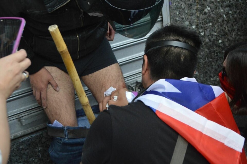 CHAOS: Protesters treating wounds caused by military police.