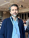 Anders Buhaug står foran andre deltakere i et lyst lokale, med NTNU-adgangskort rundt halsen.